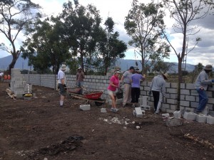 Everybody pitching in laying block